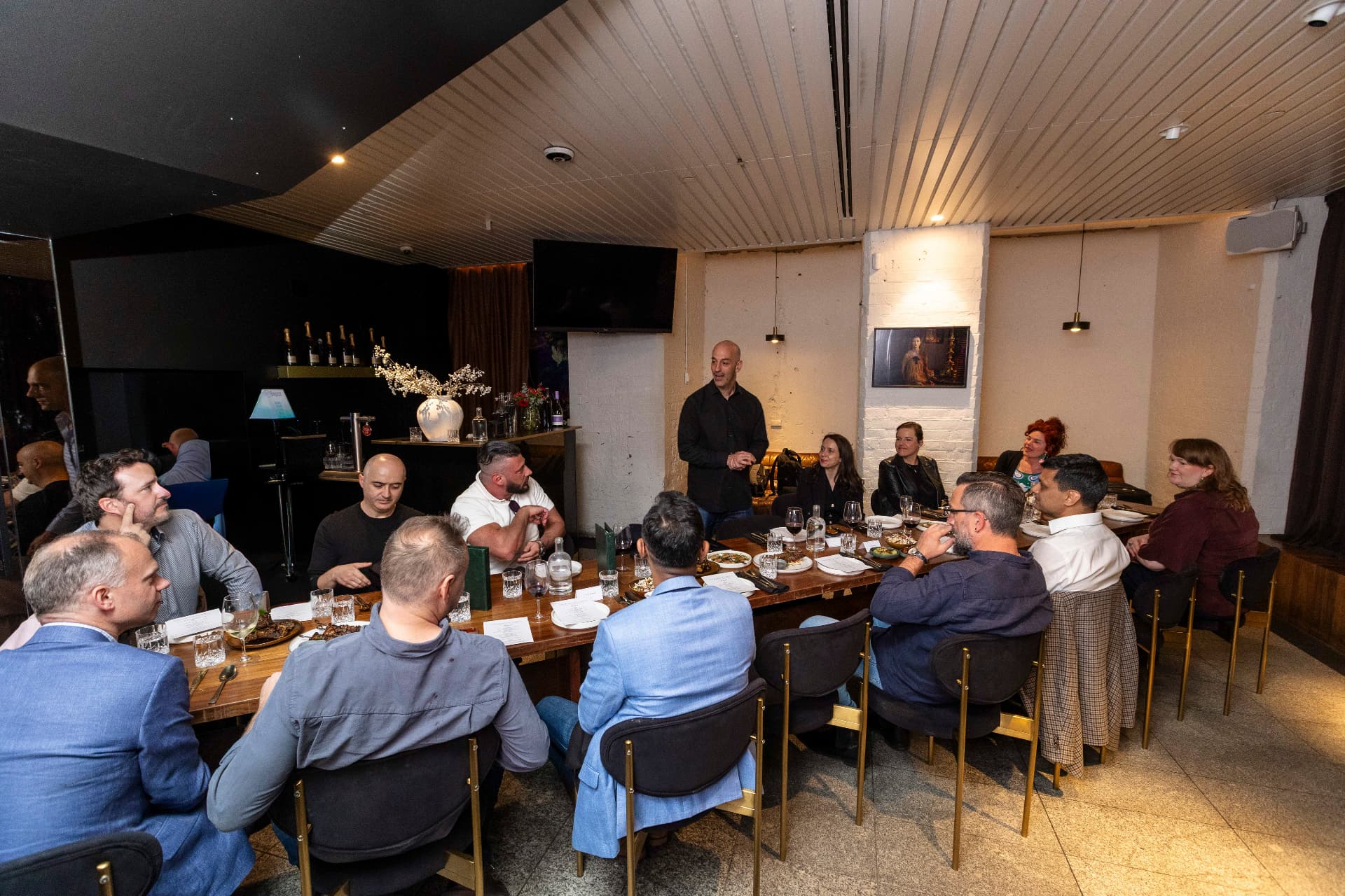 Retail professionals gathered around a table at a community dinner